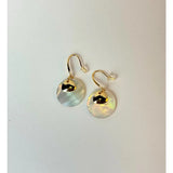 Gold earrings with round, light-colored stones on a white background