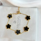 Gold bracelet with black flower-shaped charms on a Zirconiq Jewellery branded card.