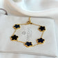 Gold bracelet with black flowers on a Zirconio Jewellers card