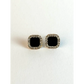 Pair of square black gemstone earrings with silver borders on a white background