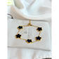 Gold bracelet with black flowers on a Zirconio Jewellers card