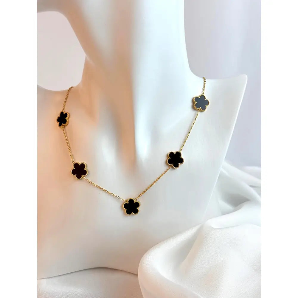 Necklace with black flower pendants on a white background
