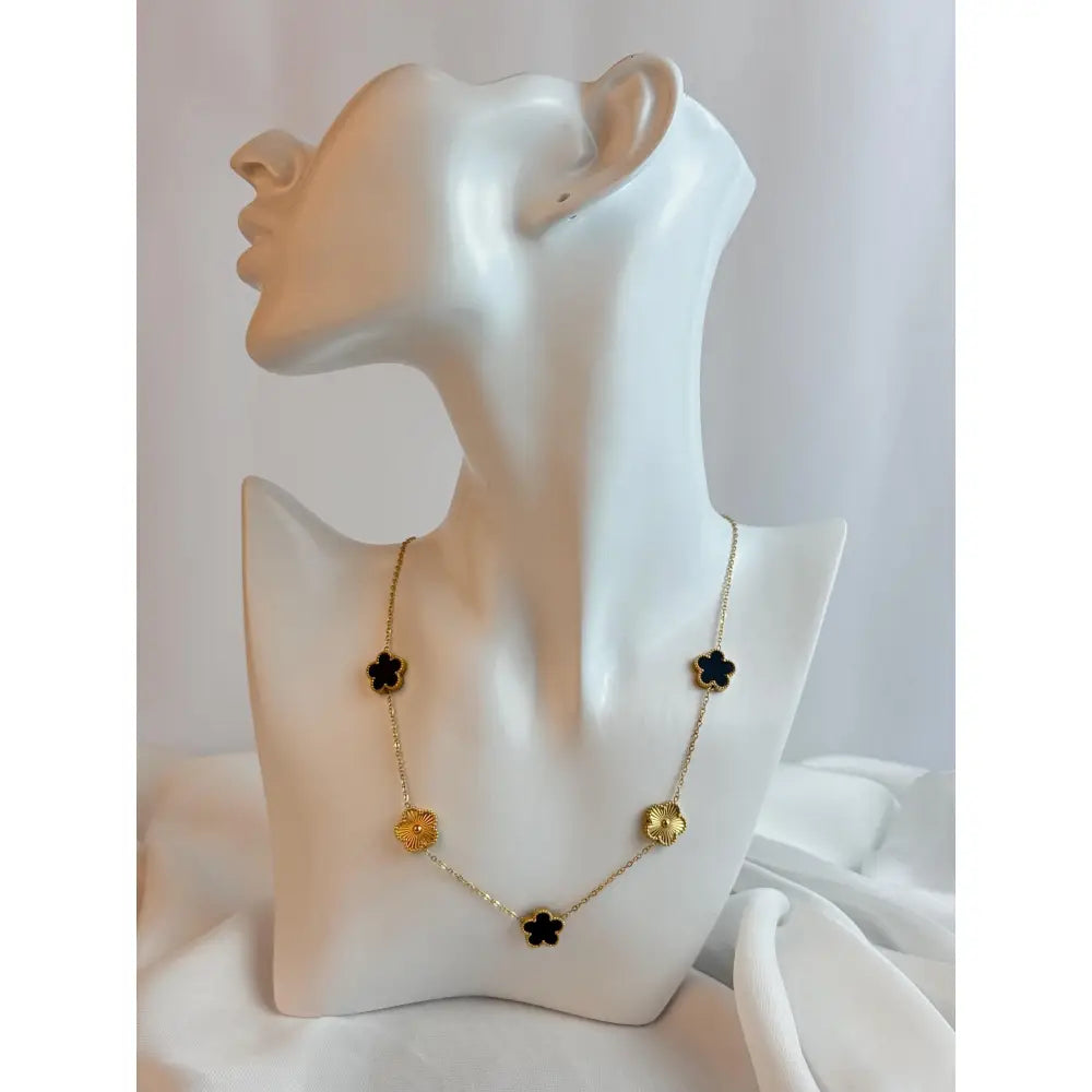 Necklace with floral pendants on a mannequin bust against a white background
