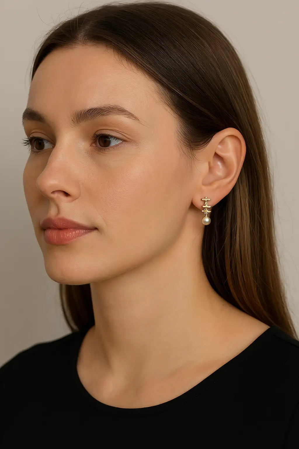 Gold-toned drop earrings featuring a delicate chain link design with a single pearl at the bottom.