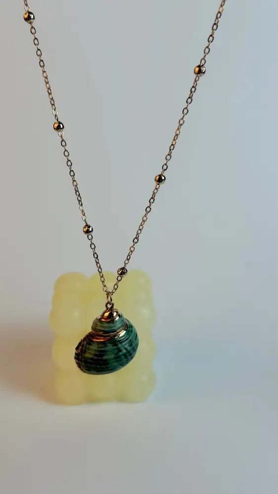 Necklace with a green pendant on a white background