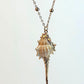 Shell pendant necklace on a light gray background