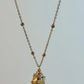 Necklace with a small pendant on a light gray background